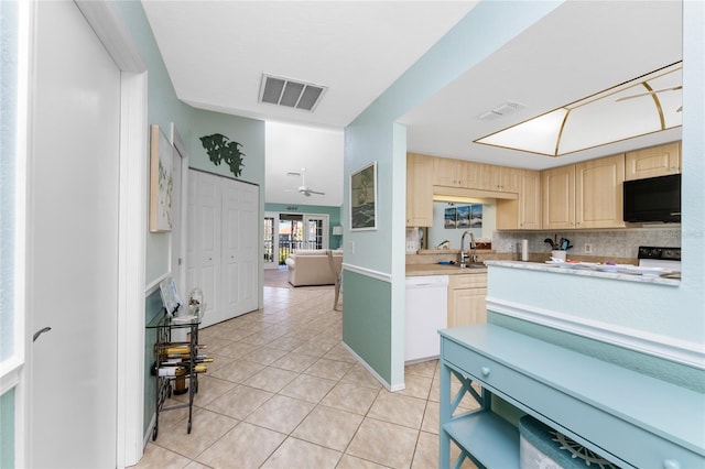 kitchen featuring decorative backsplash, white dishwasher, light brown cabinetry, light tile patterned flooring, and sink