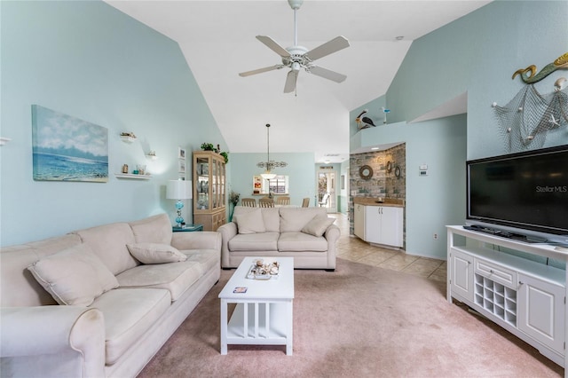 living room featuring high vaulted ceiling, light tile patterned floors, and ceiling fan