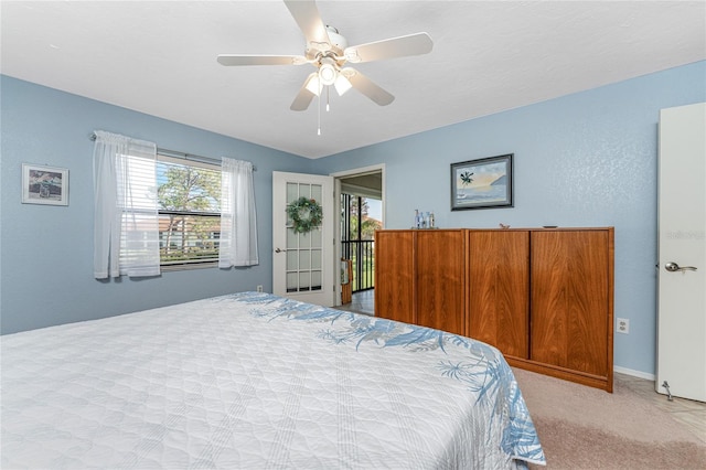 carpeted bedroom featuring ceiling fan and multiple windows