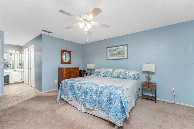 404 Pine Hollow Cir Unit 404, Englewood, FL 34223 - carpeted bedroom with baseboards, ceiling fan, and ensuite bath