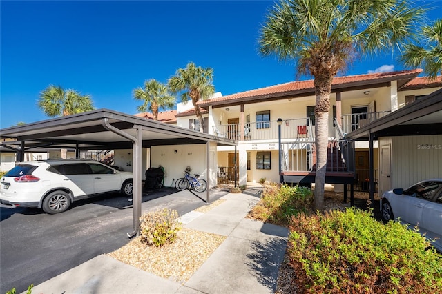 view of front of house with a carport and a balcony