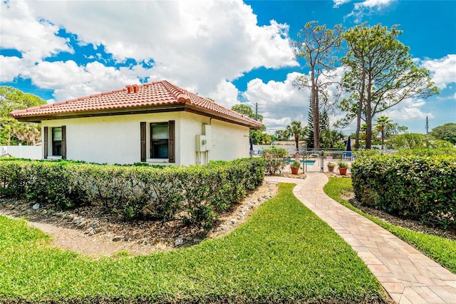 404 Pine Hollow Cir Unit 404, Englewood, FL 34223 - view of side of home with a tile roof and stucco siding