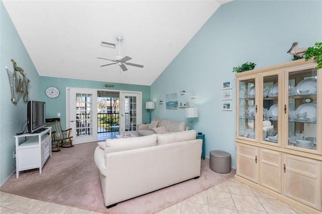 living room featuring ceiling fan, light tile patterned floors, high vaulted ceiling, and french doors