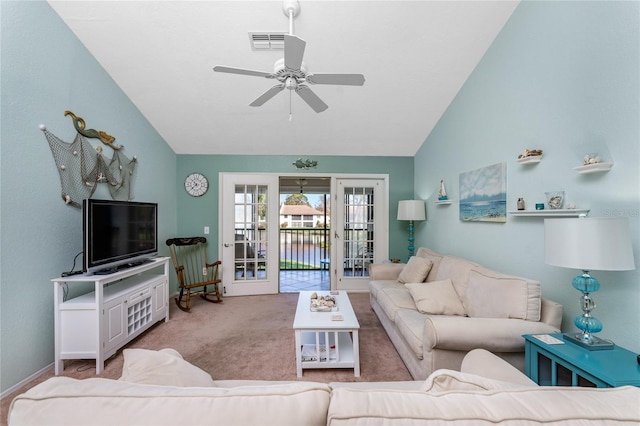 carpeted living room with lofted ceiling, ceiling fan, and french doors