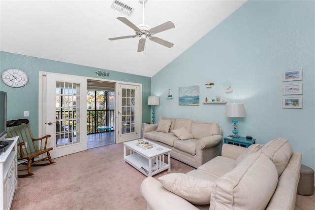 living room with ceiling fan, high vaulted ceiling, french doors, and light colored carpet