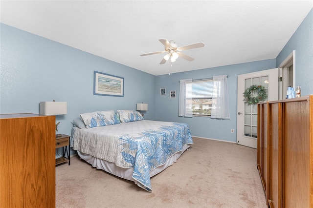 bedroom with light carpet and ceiling fan