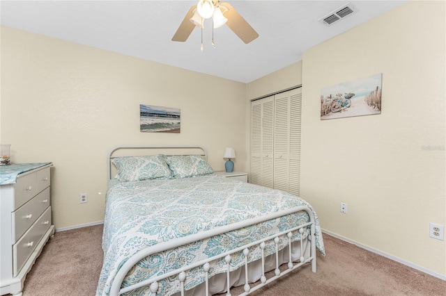 bedroom with light carpet, ceiling fan, and a closet