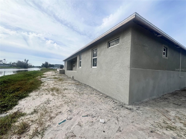 view of side of home featuring a water view