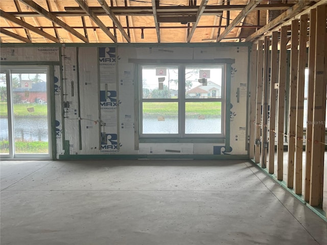 miscellaneous room featuring concrete floors and a water view