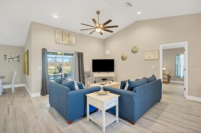 living room with high vaulted ceiling, light hardwood / wood-style floors, and ceiling fan