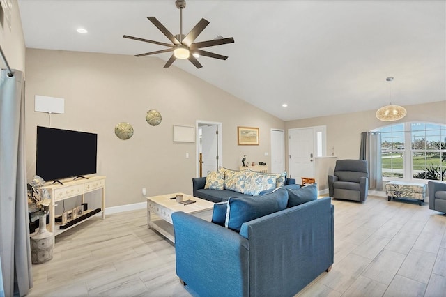 living room featuring light hardwood / wood-style floors, lofted ceiling, and ceiling fan