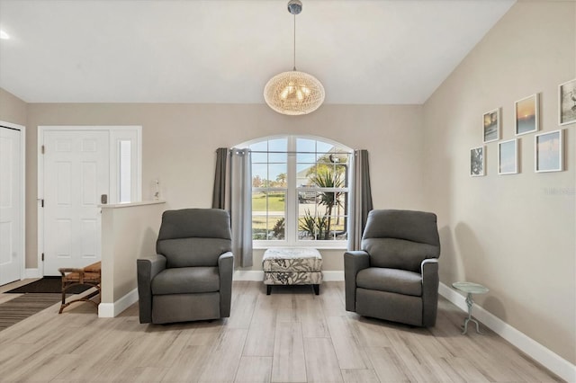 sitting room featuring vaulted ceiling and light wood-type flooring