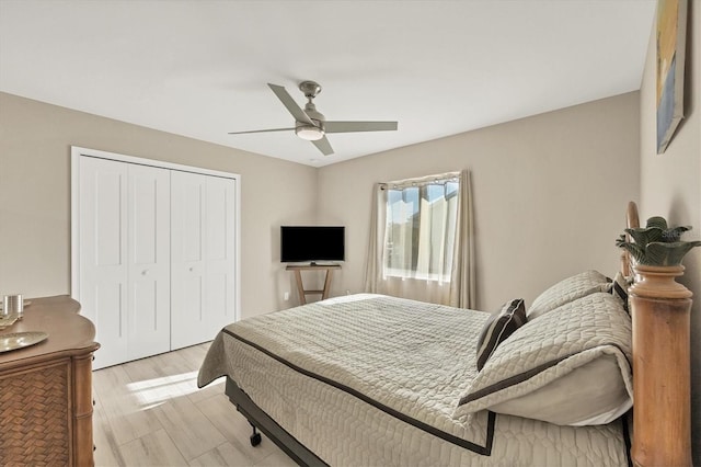 bedroom featuring a closet, light wood-type flooring, and ceiling fan