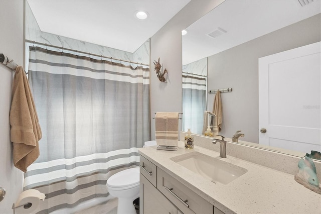 bathroom featuring vanity, toilet, and a shower with shower curtain