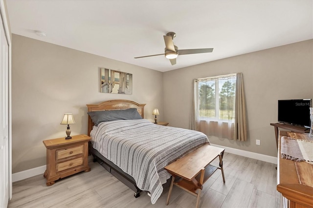 bedroom with ceiling fan and light hardwood / wood-style floors