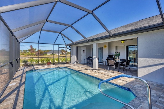 view of swimming pool featuring a patio and glass enclosure