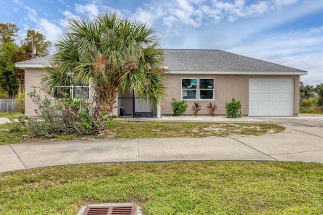 view of front facade with a garage and a front yard