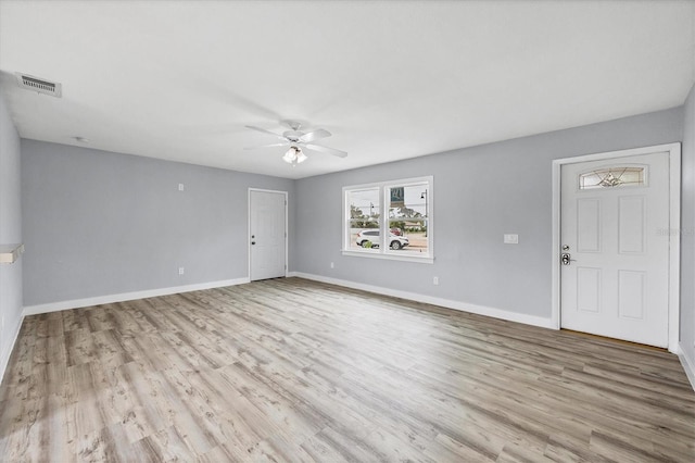 empty room with ceiling fan and light hardwood / wood-style flooring