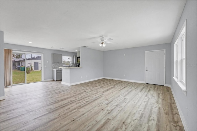 unfurnished living room featuring light wood-type flooring and ceiling fan