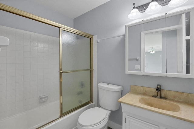 full bathroom featuring shower / bath combination with glass door, ceiling fan, toilet, and vanity