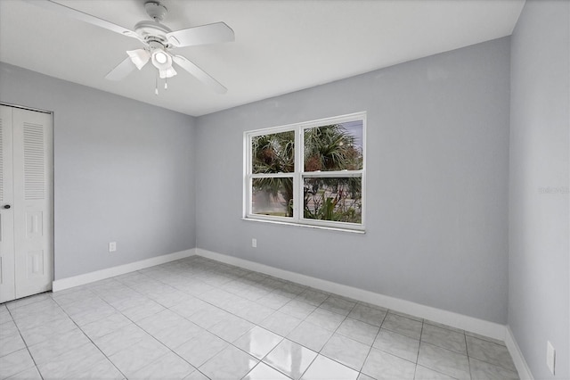 tiled empty room with ceiling fan