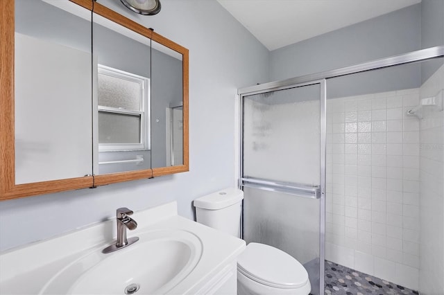 bathroom featuring walk in shower, vanity, and toilet