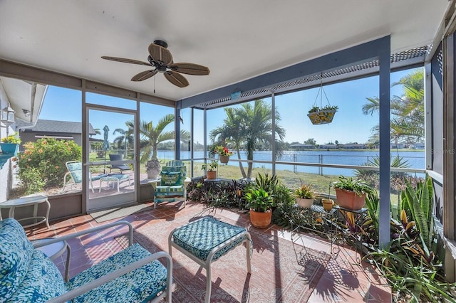 sunroom / solarium featuring a water view, a wealth of natural light, and ceiling fan