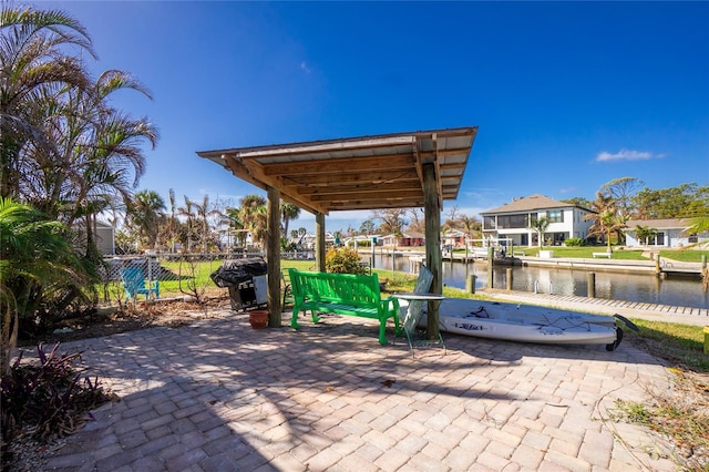 view of patio / terrace with a water view and grilling area