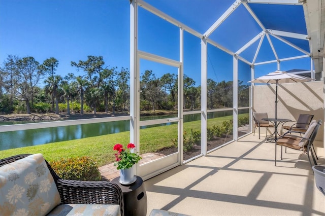 unfurnished sunroom featuring a water view