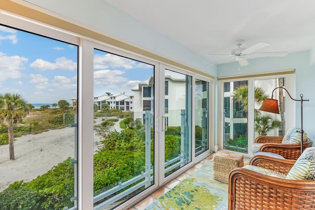 sunroom / solarium with a wealth of natural light and ceiling fan