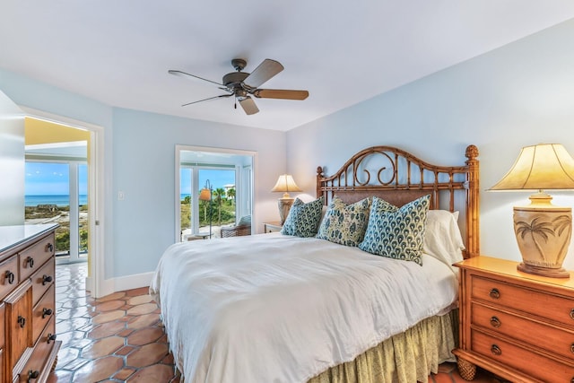 tiled bedroom with ceiling fan, a water view, and access to outside