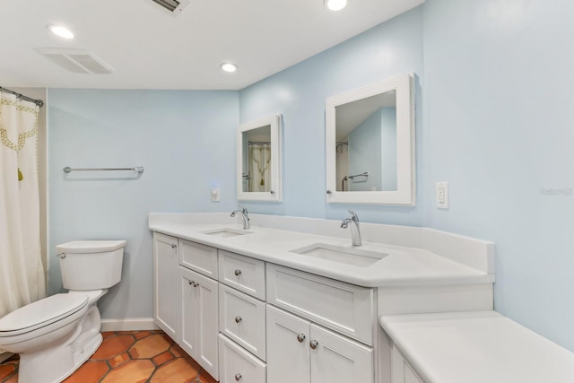 bathroom with tile patterned flooring, vanity, and toilet