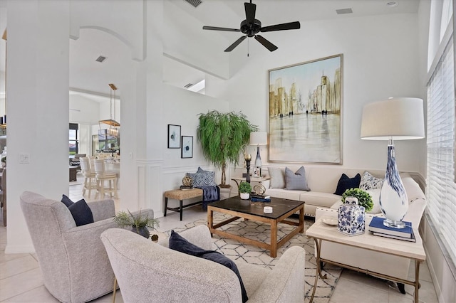 tiled living room with a healthy amount of sunlight and a high ceiling