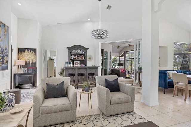 living room with light tile patterned floors, a notable chandelier, and high vaulted ceiling