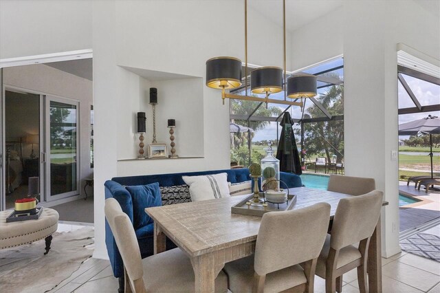 dining area with a towering ceiling and light tile patterned floors