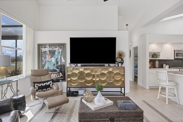 living room featuring lofted ceiling and light tile patterned floors