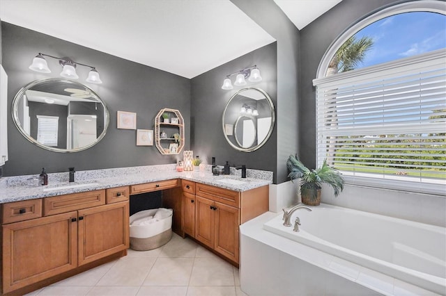 bathroom with vanity, tiled tub, and tile patterned flooring