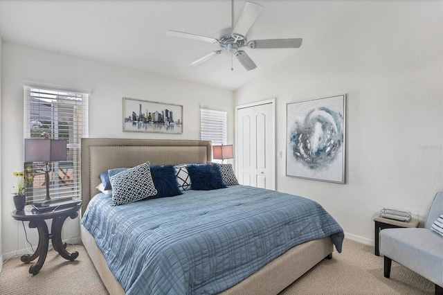 carpeted bedroom featuring vaulted ceiling, a closet, and ceiling fan