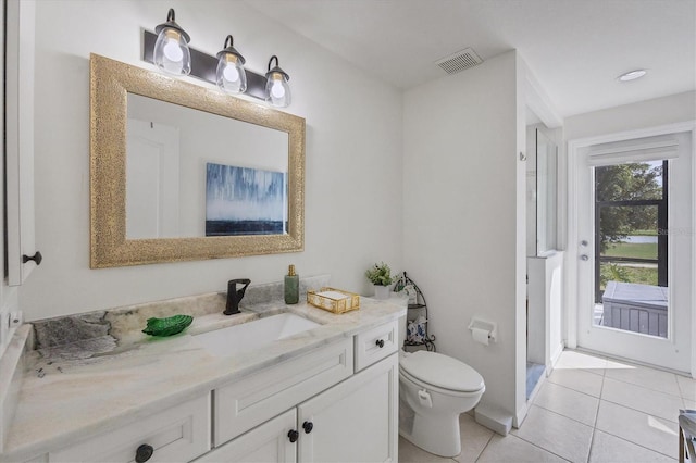 bathroom featuring tile patterned flooring, vanity, and toilet