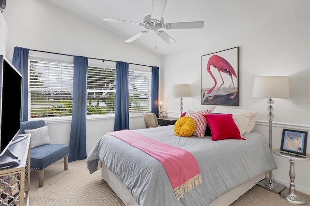 carpeted bedroom with ceiling fan and vaulted ceiling