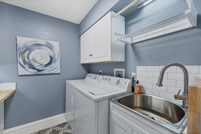 washroom featuring cabinets, tile patterned flooring, sink, and washing machine and clothes dryer