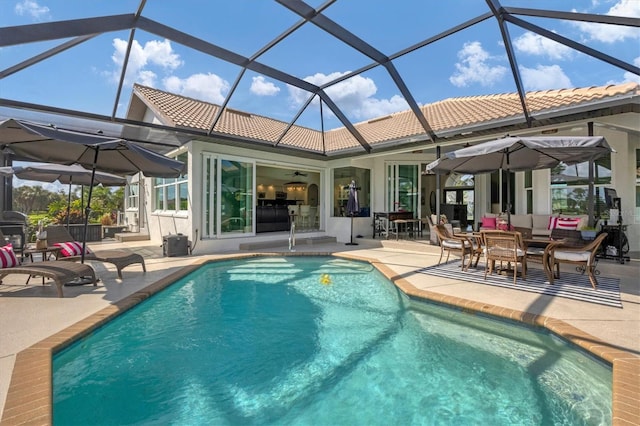 view of pool featuring a patio, a lanai, and ceiling fan