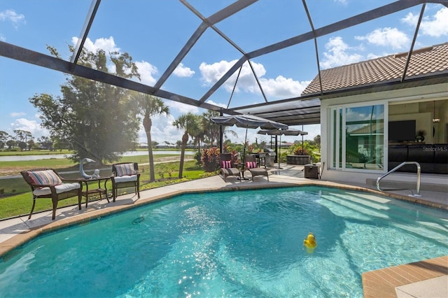 view of swimming pool with a lanai and a patio area