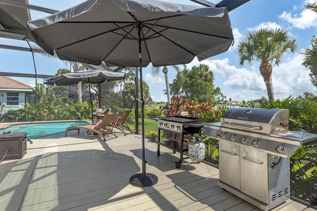 wooden deck with a grill and glass enclosure