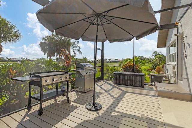 deck featuring cooling unit and grilling area