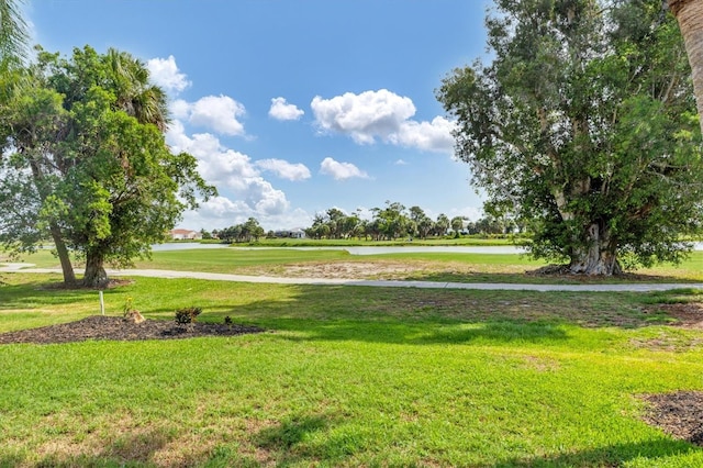 view of property's community featuring a water view and a lawn