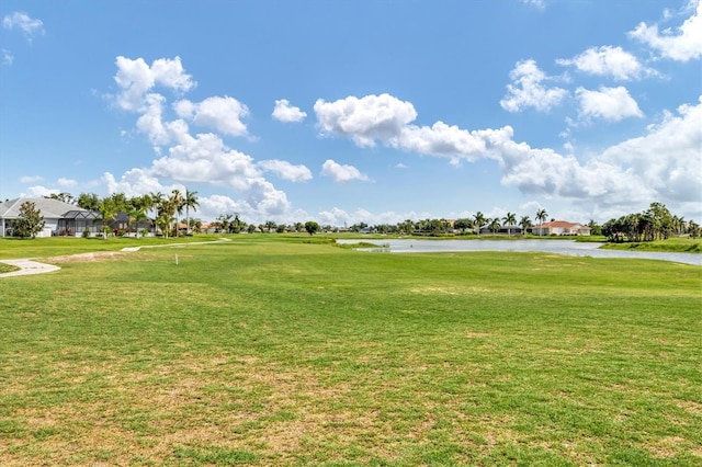 view of community with a yard and a water view