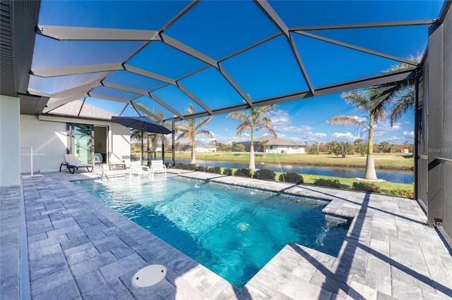 view of pool with a patio, a water view, and glass enclosure