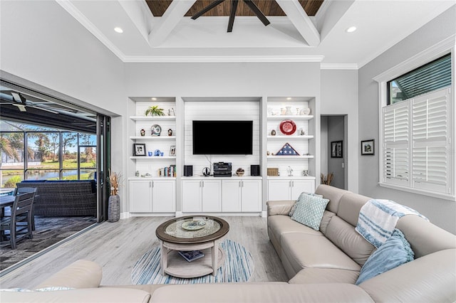 living room with ornamental molding, a high ceiling, beamed ceiling, and light wood-type flooring