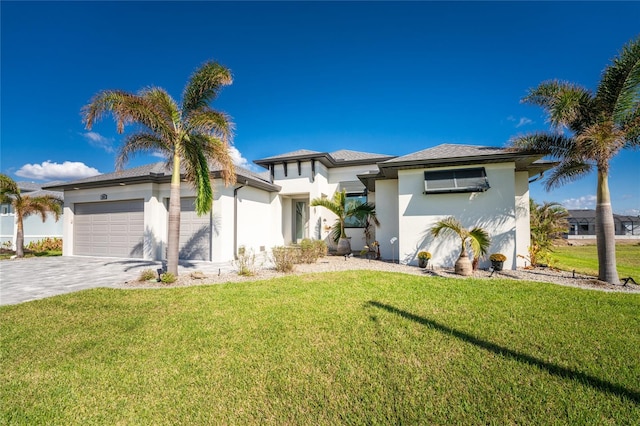 view of front of home with a front yard and a garage